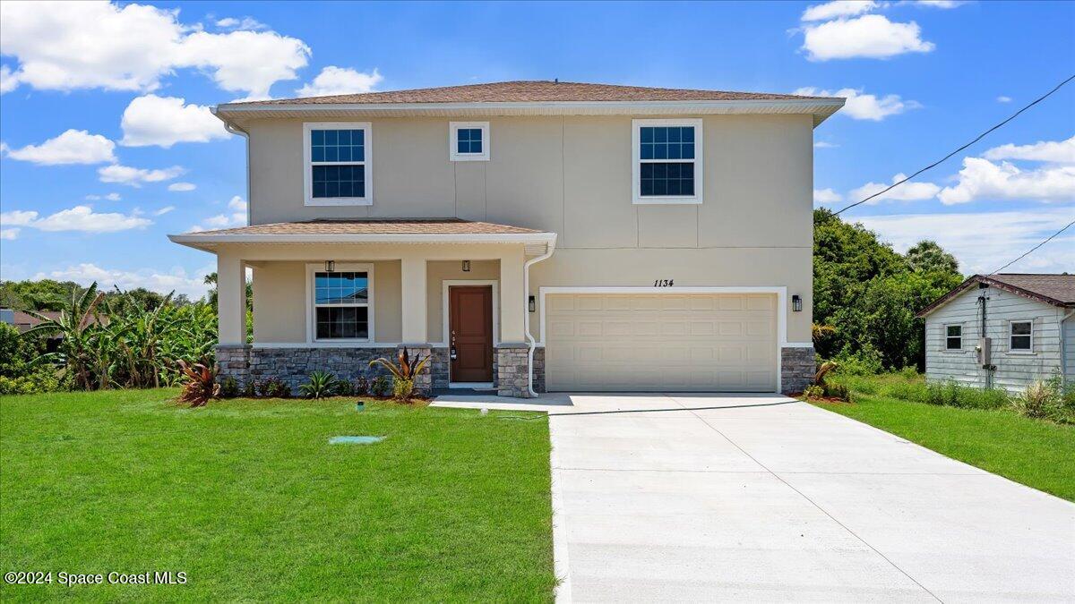 a front view of house with yard and green space