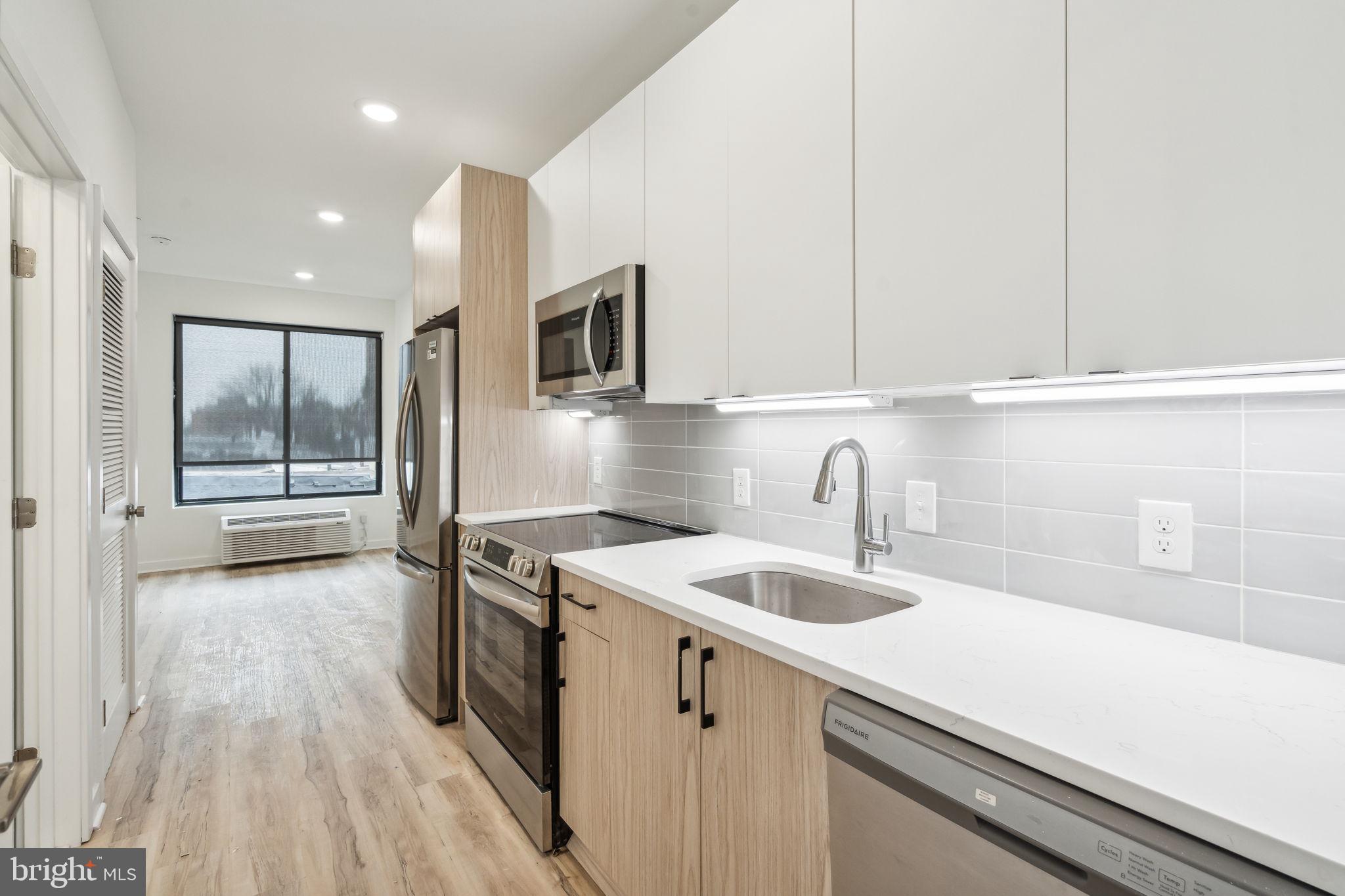 a kitchen with a sink and cabinets