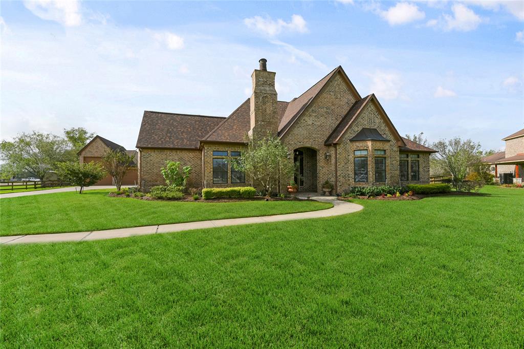 Presenting 6619 Crown Oak Court in heralded Brazos Lakes Subdivision! Curb Appeal features a prominent Gable Roof and Arched Entryway, complemented by a well-manicured lawn and a curved Walkway leading to the front door.