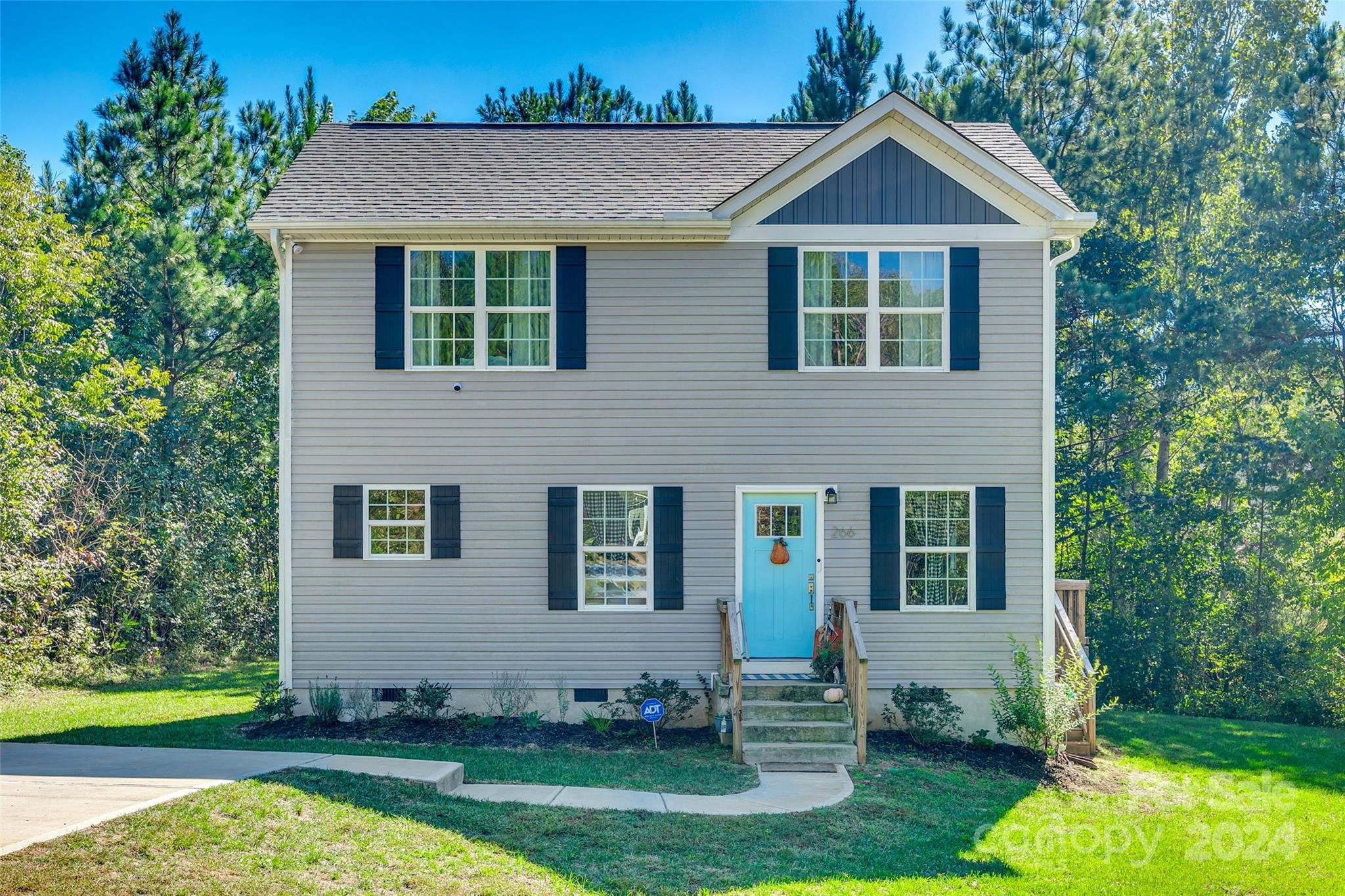 a front view of a house with garden