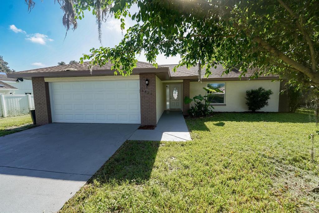 a front view of a house with a yard and garage