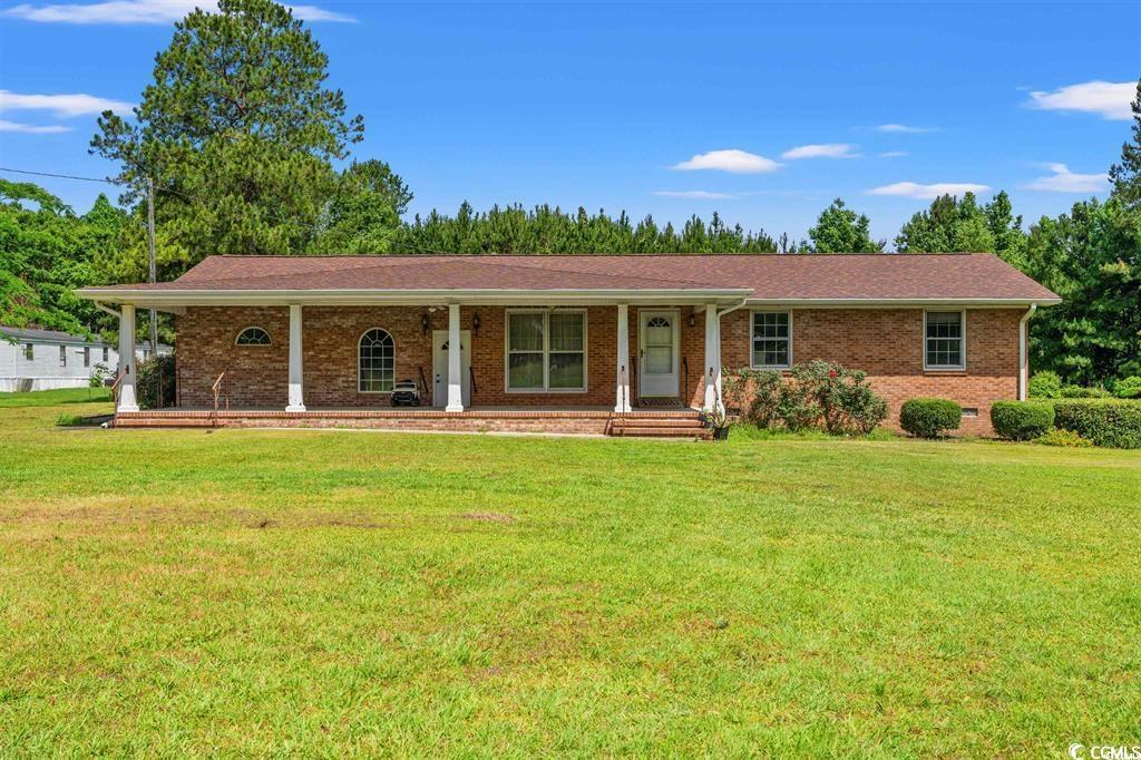 Ranch-style house featuring a front lawn