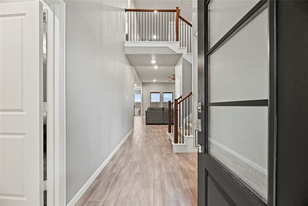 a view of hallway with wooden floor