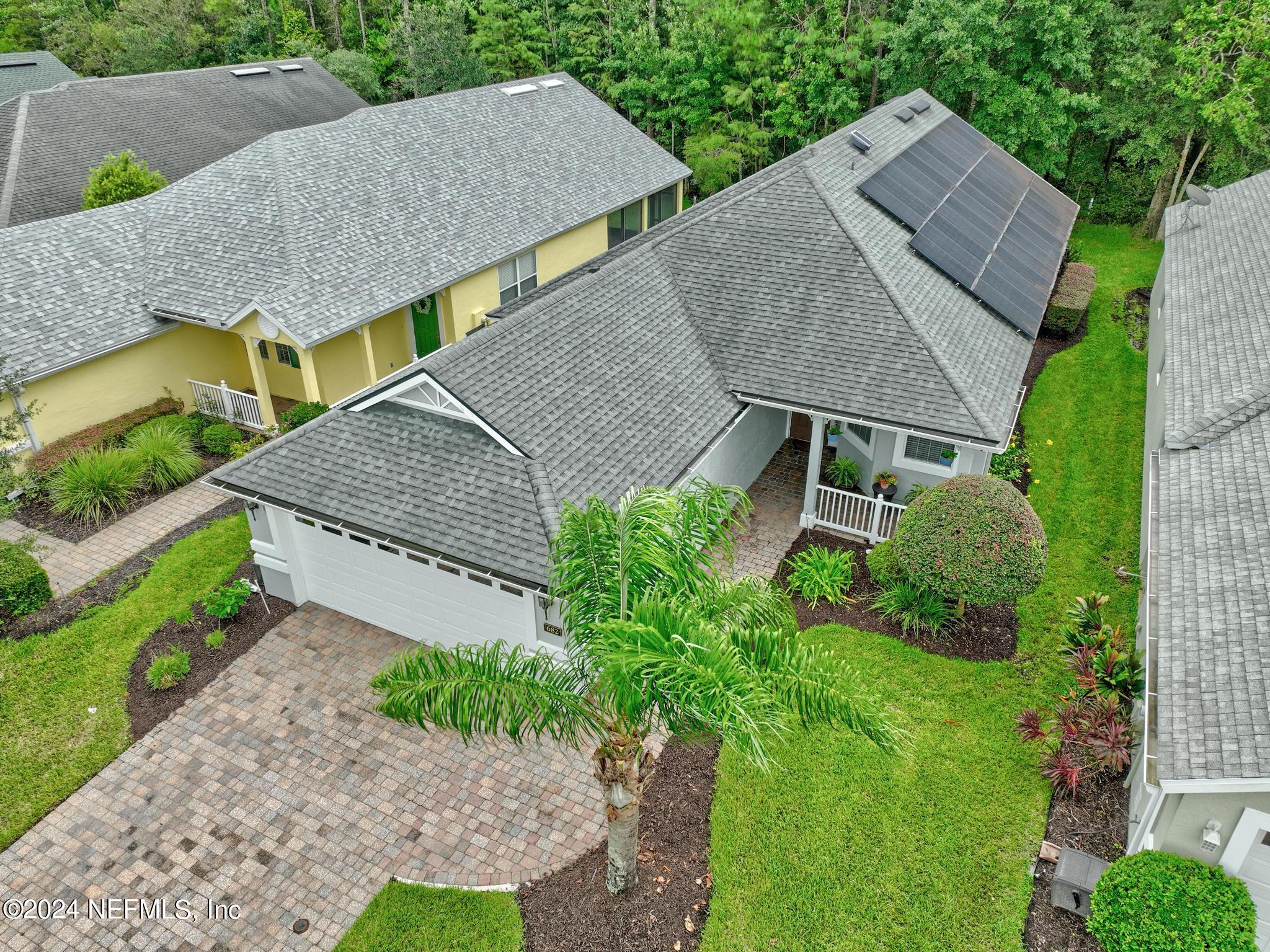 an aerial view of a house with a yard and plants