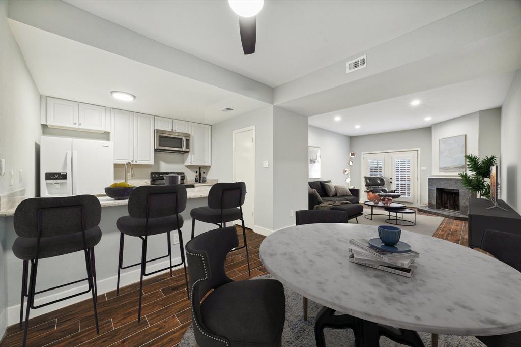 a kitchen with sink refrigerator dining table and chairs