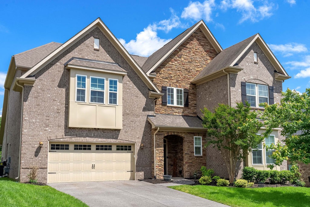 a front view of a house with a yard