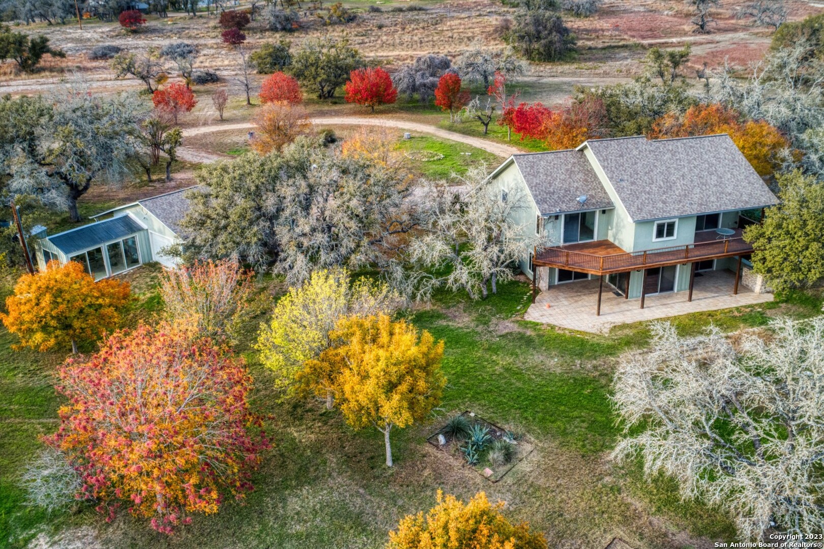 an aerial view of a house with swimming pool garden and patio