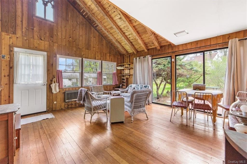 a dining room with furniture window and wooden floor