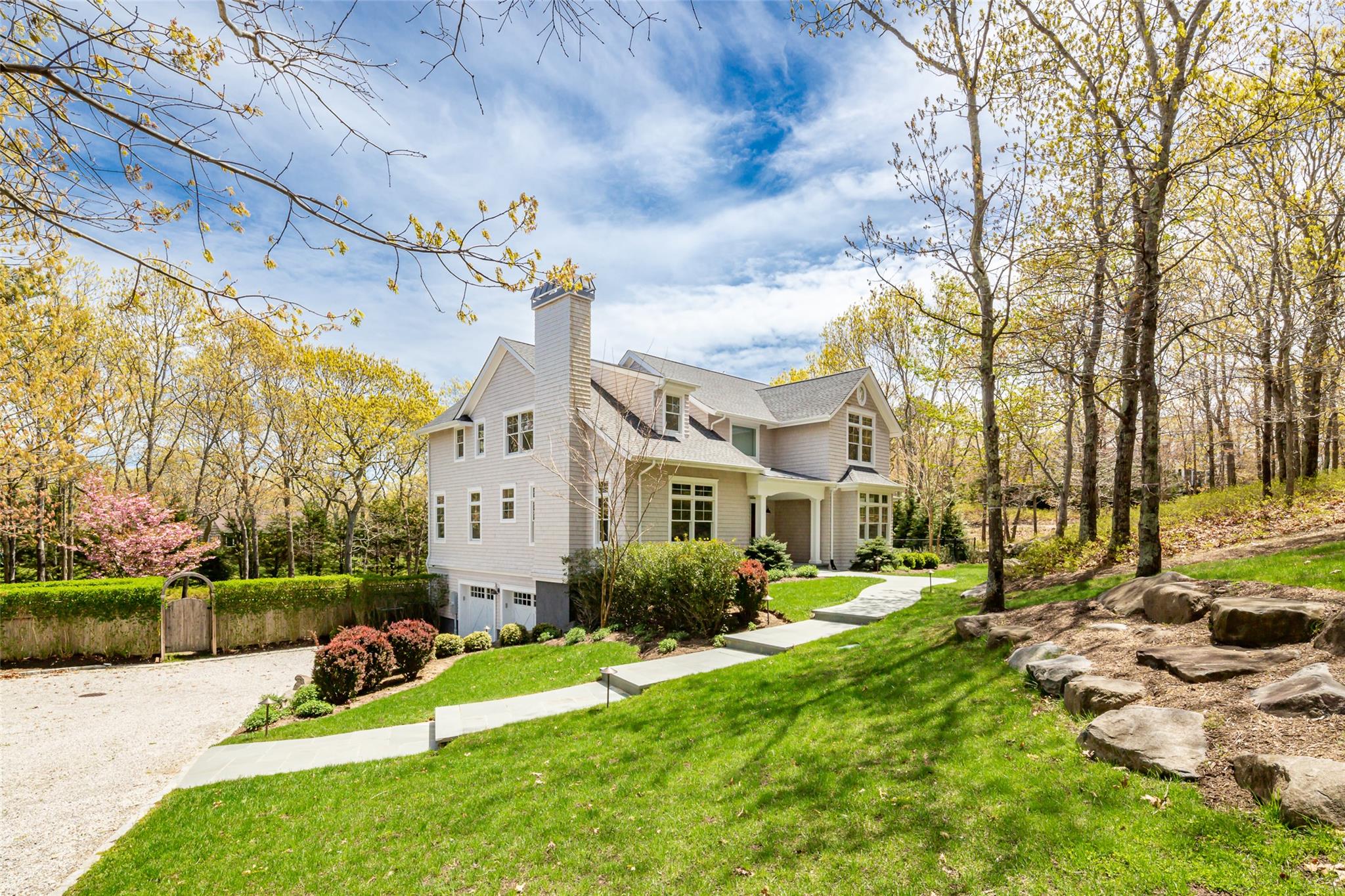 View of side of home featuring a lawn and a garage