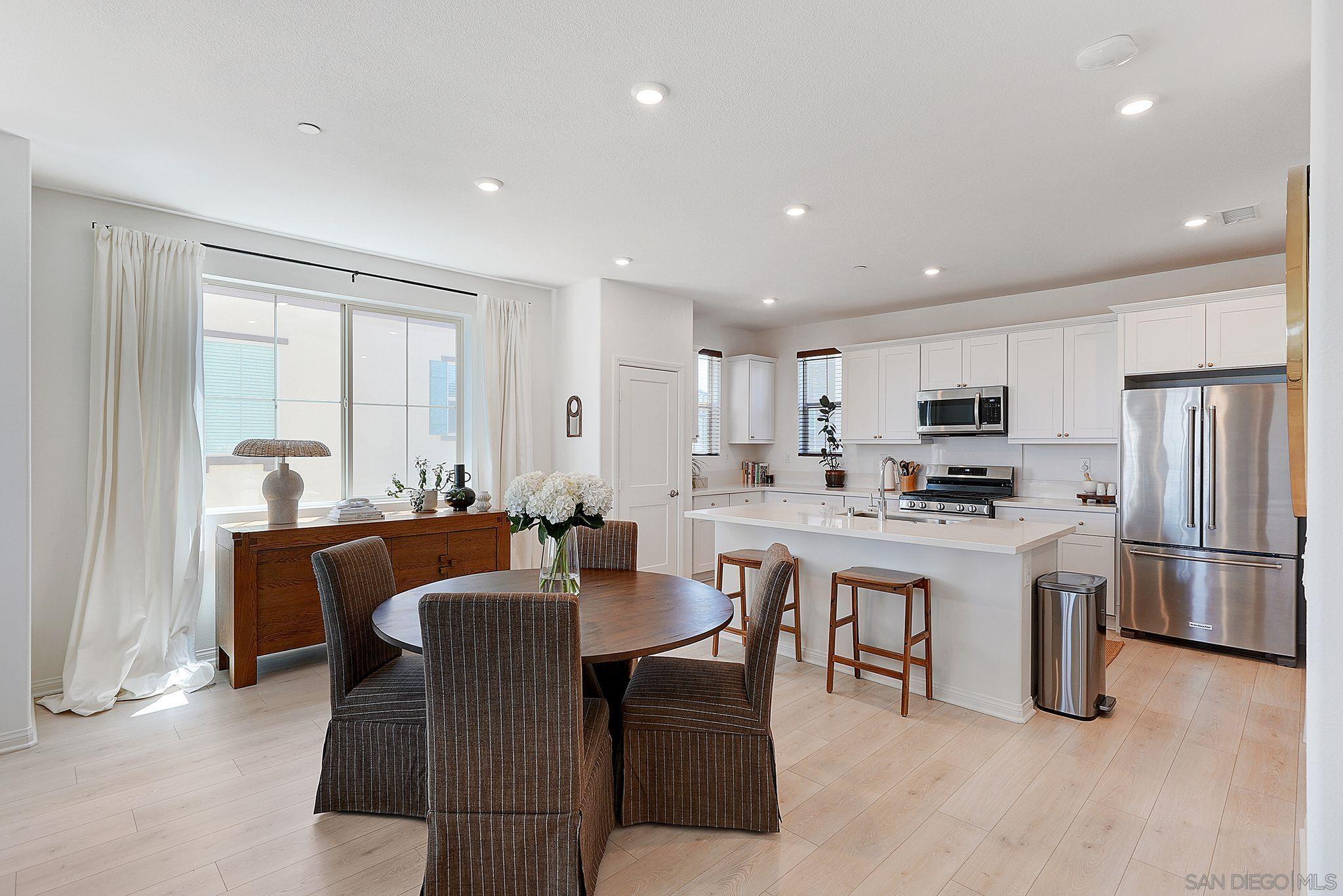 a large kitchen with a table and chairs