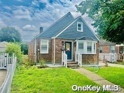 a view of a house with a yard and front view of a house