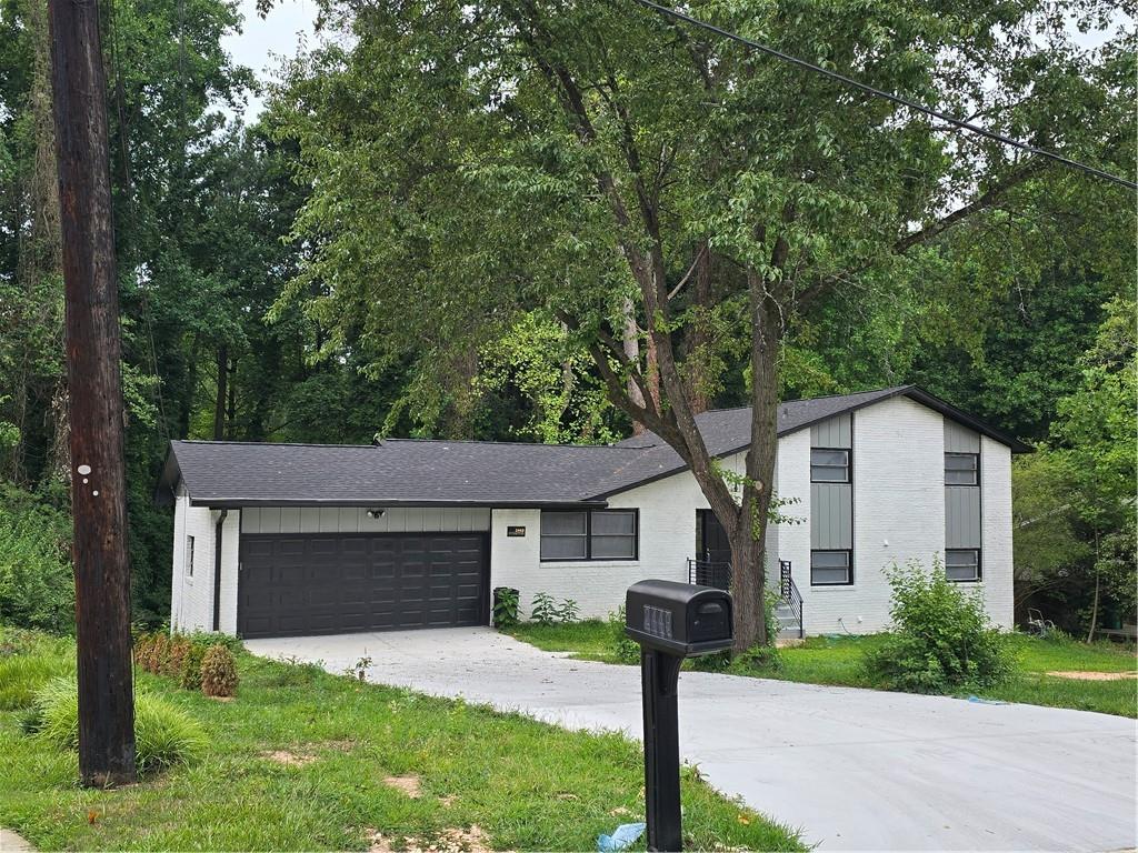 a front view of a house with a garden and yard