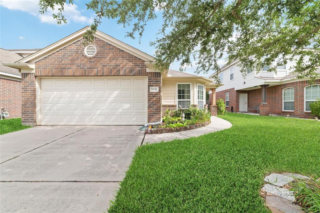 a front view of a house with a yard and garage