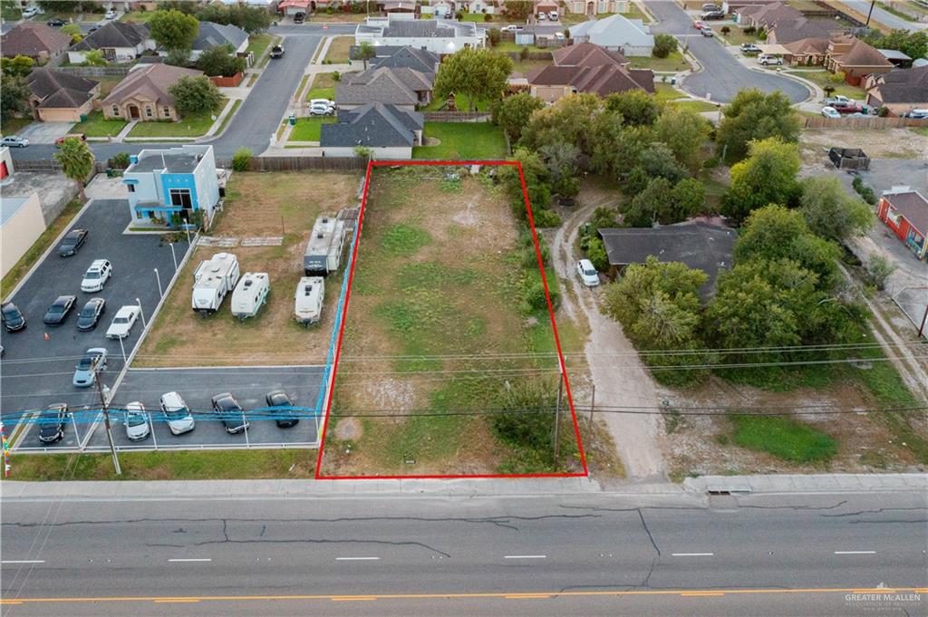 an aerial view of a residential houses with yard