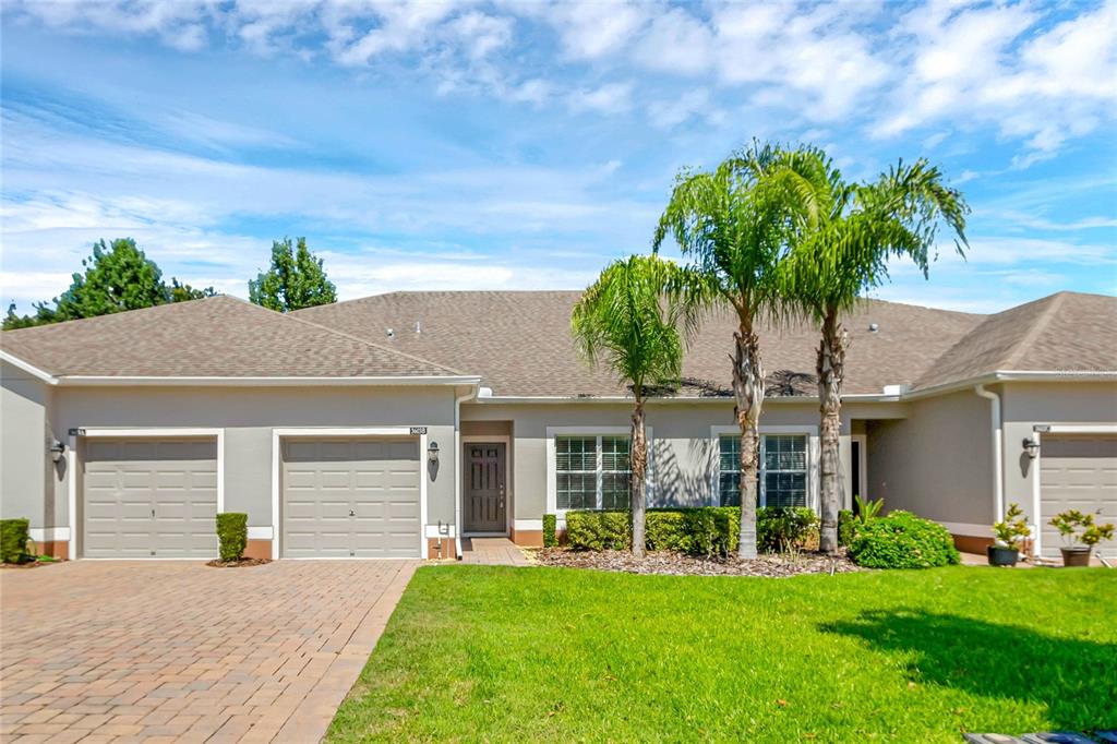 a front view of a house with a yard and garage