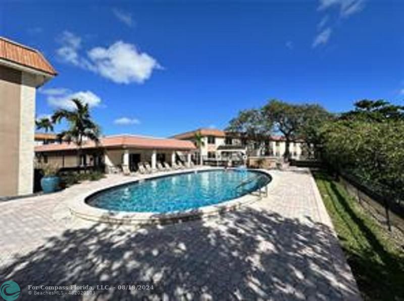 a view of a swimming pool with a yard