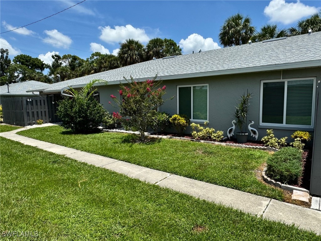 a front view of house with a garden