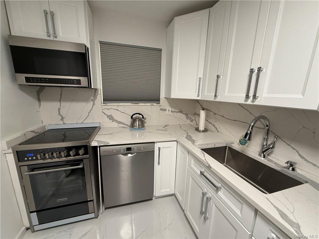 a kitchen with a sink stove and microwave