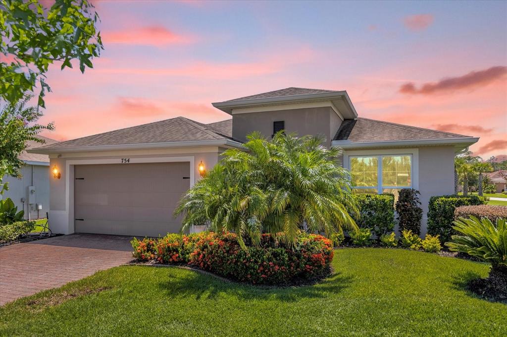 a front view of a house with a garden