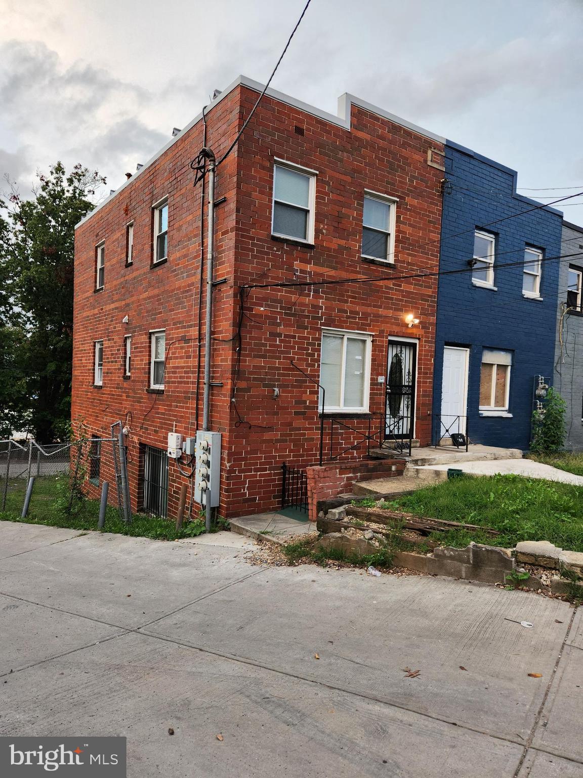 a view of a brick building next to a yard