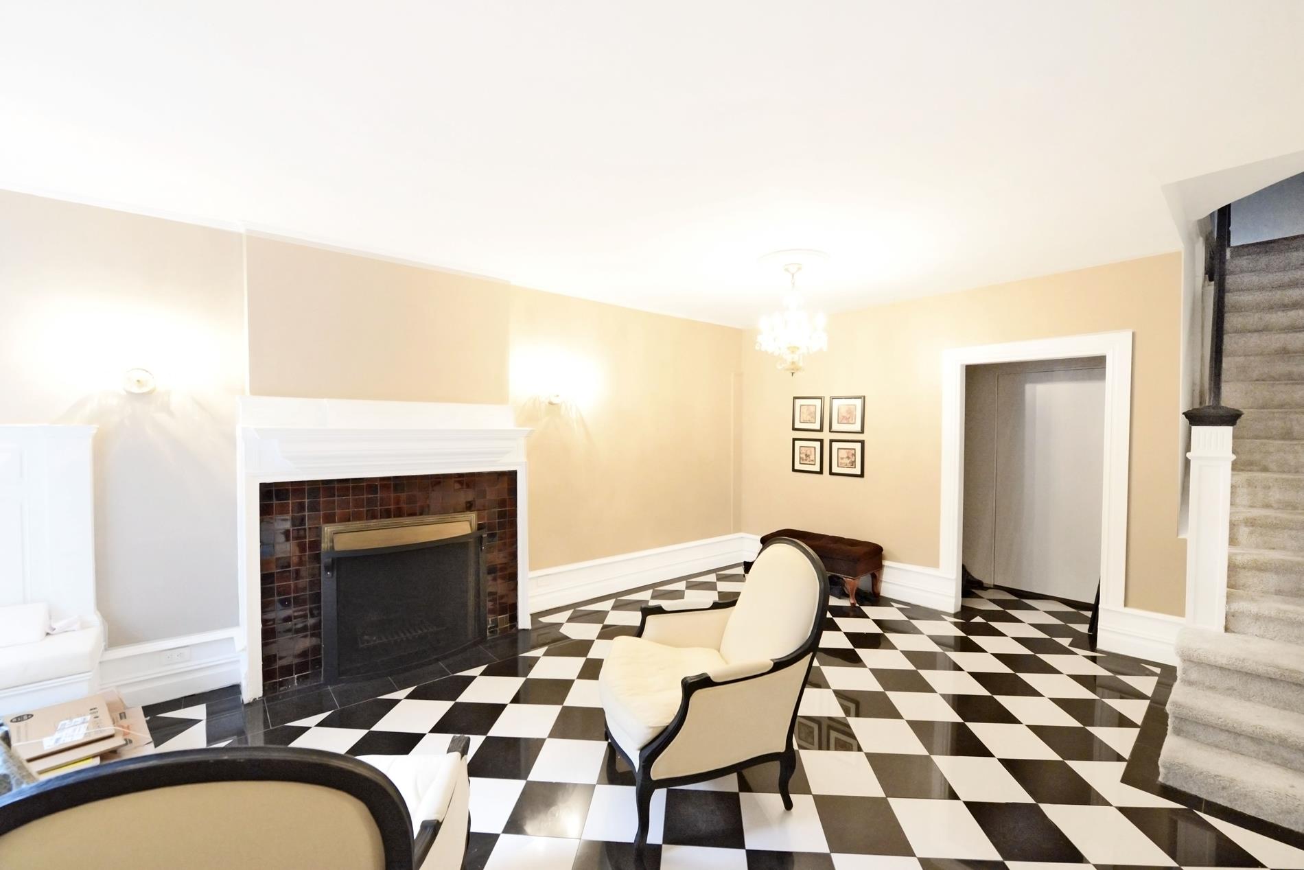 a living room with a fireplace and a rug