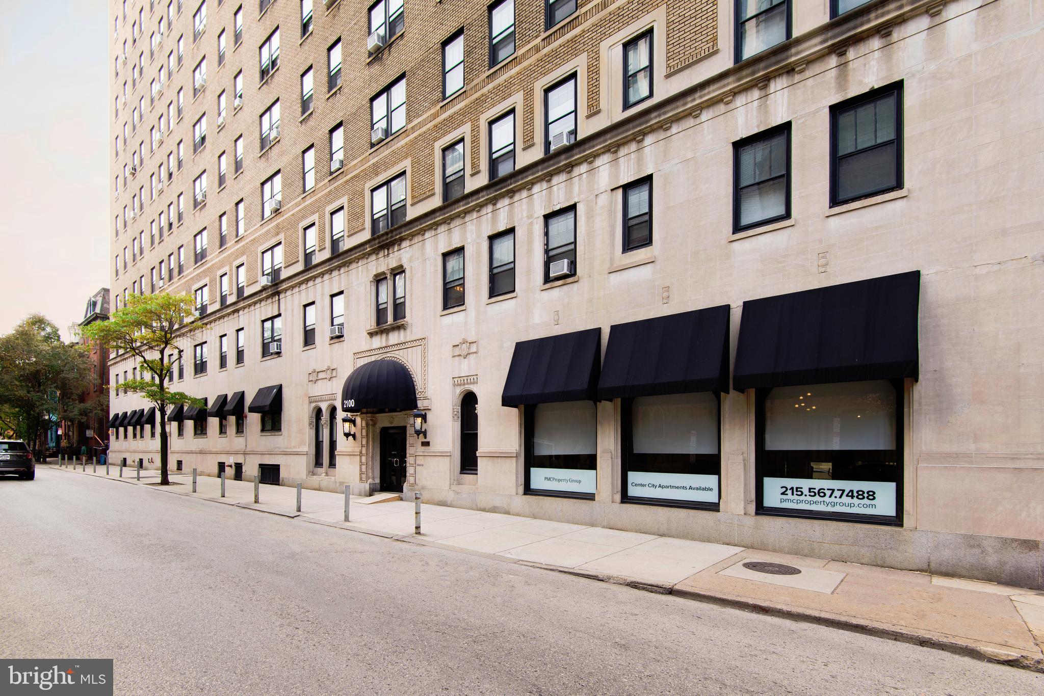 a man walking down a street next to a building