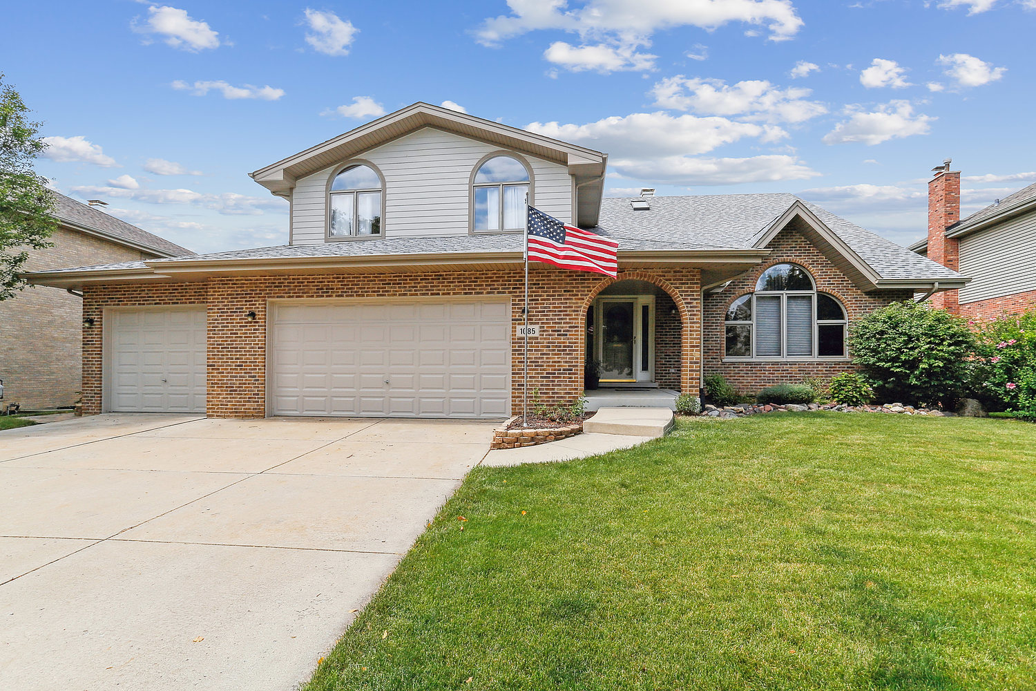 a front view of a house with a yard and garage