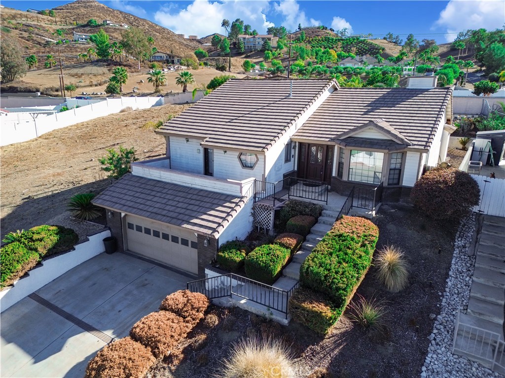 an aerial view of a house with garden space and street view