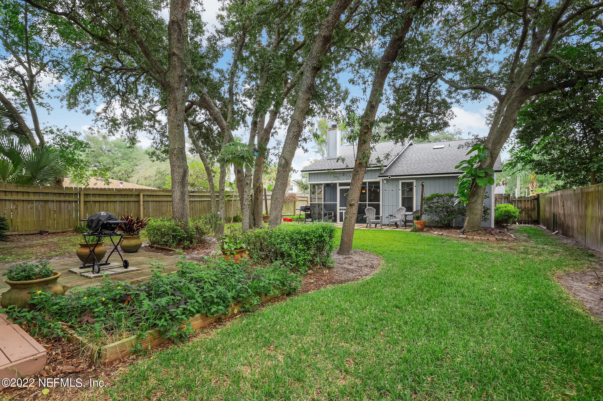 a view of backyard of house with green space