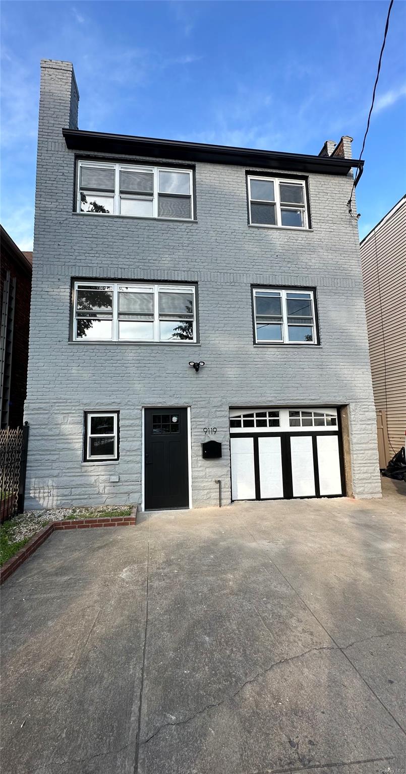 View of front of property with a garage