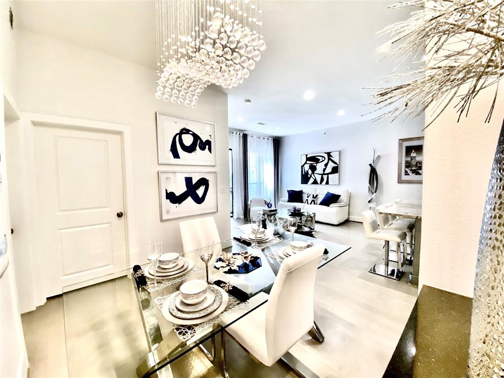 a view of a dining room with furniture and chandelier