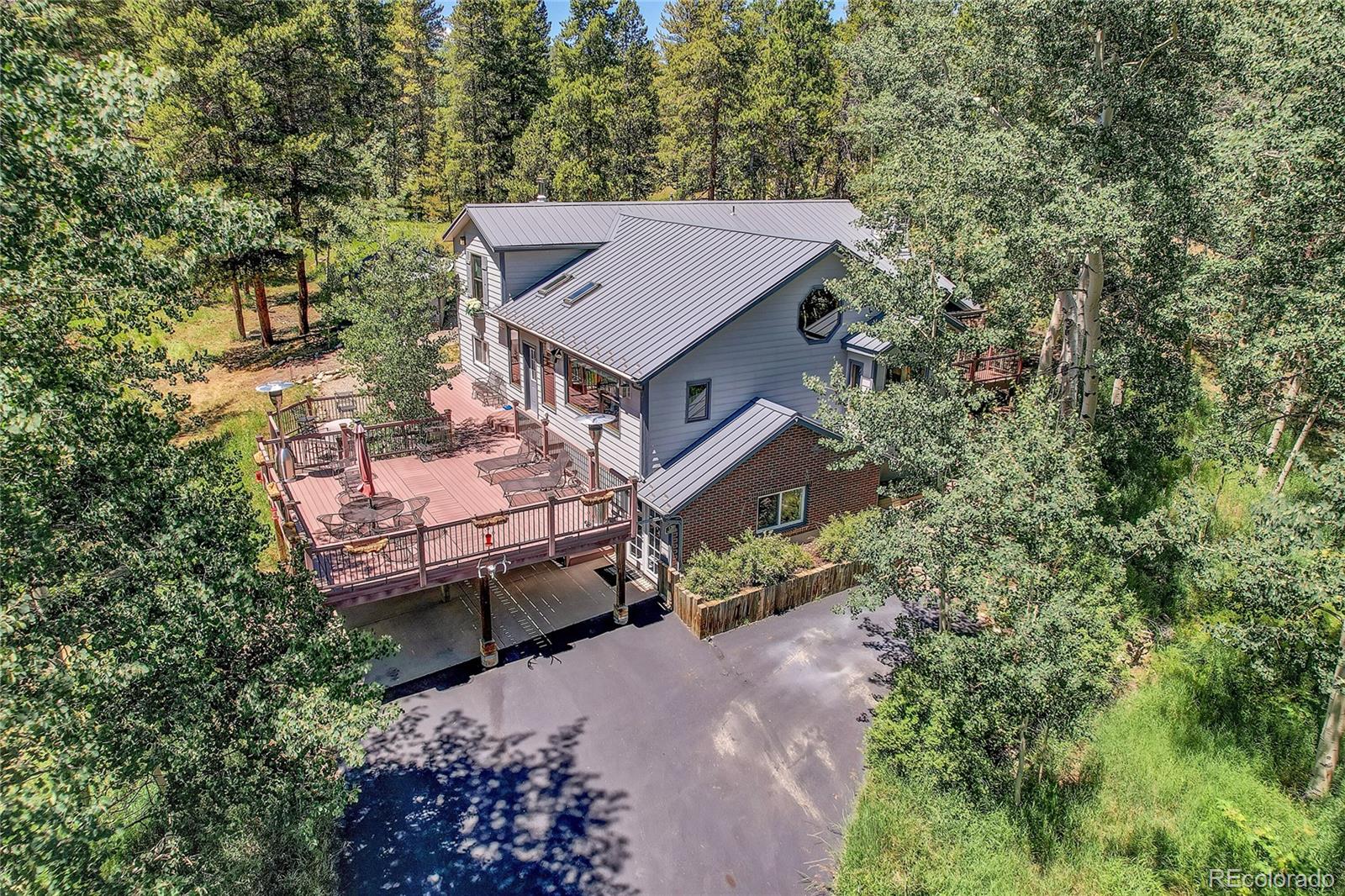 an aerial view of a house with a yard large trees