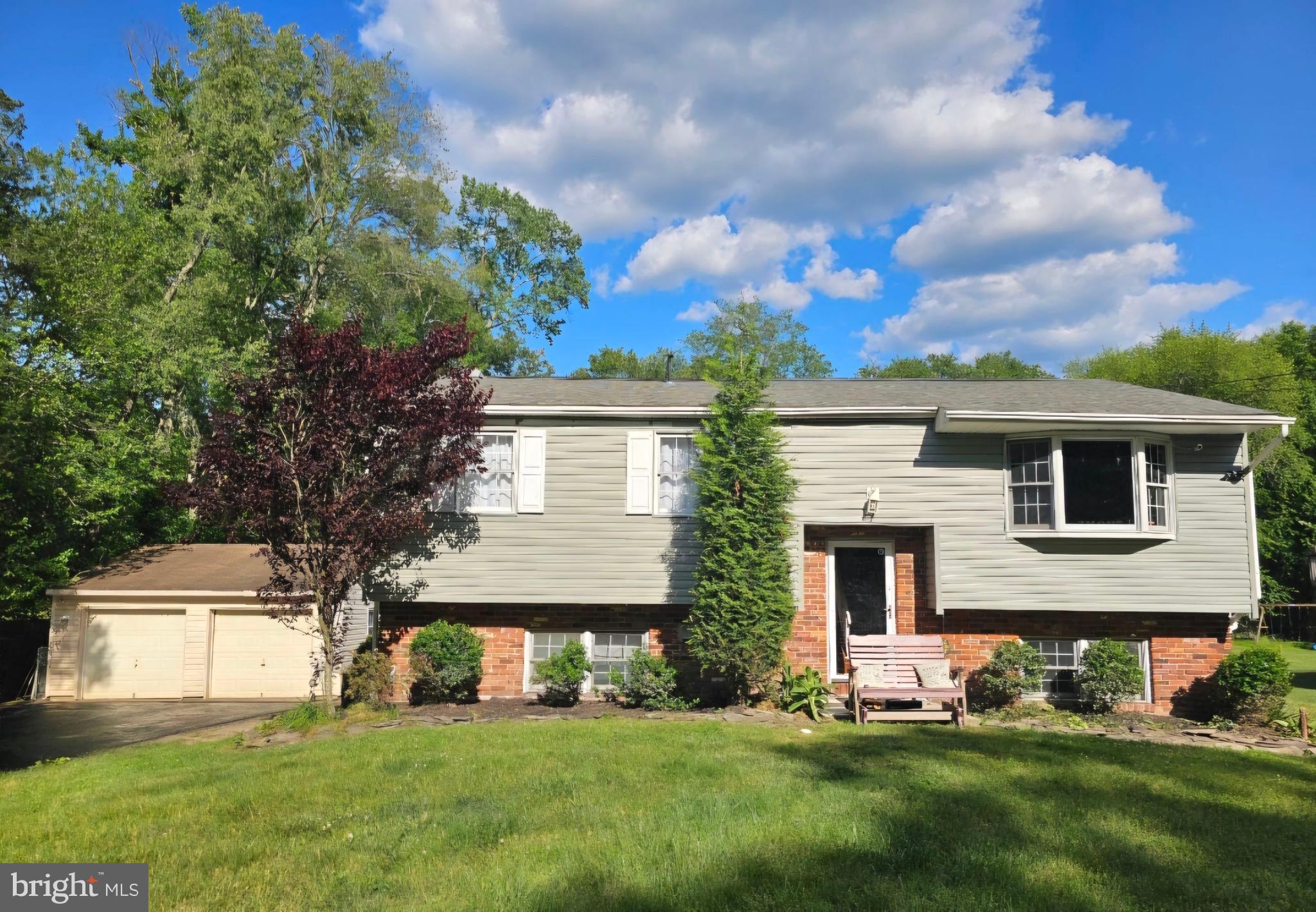 a front view of house with yard and green space