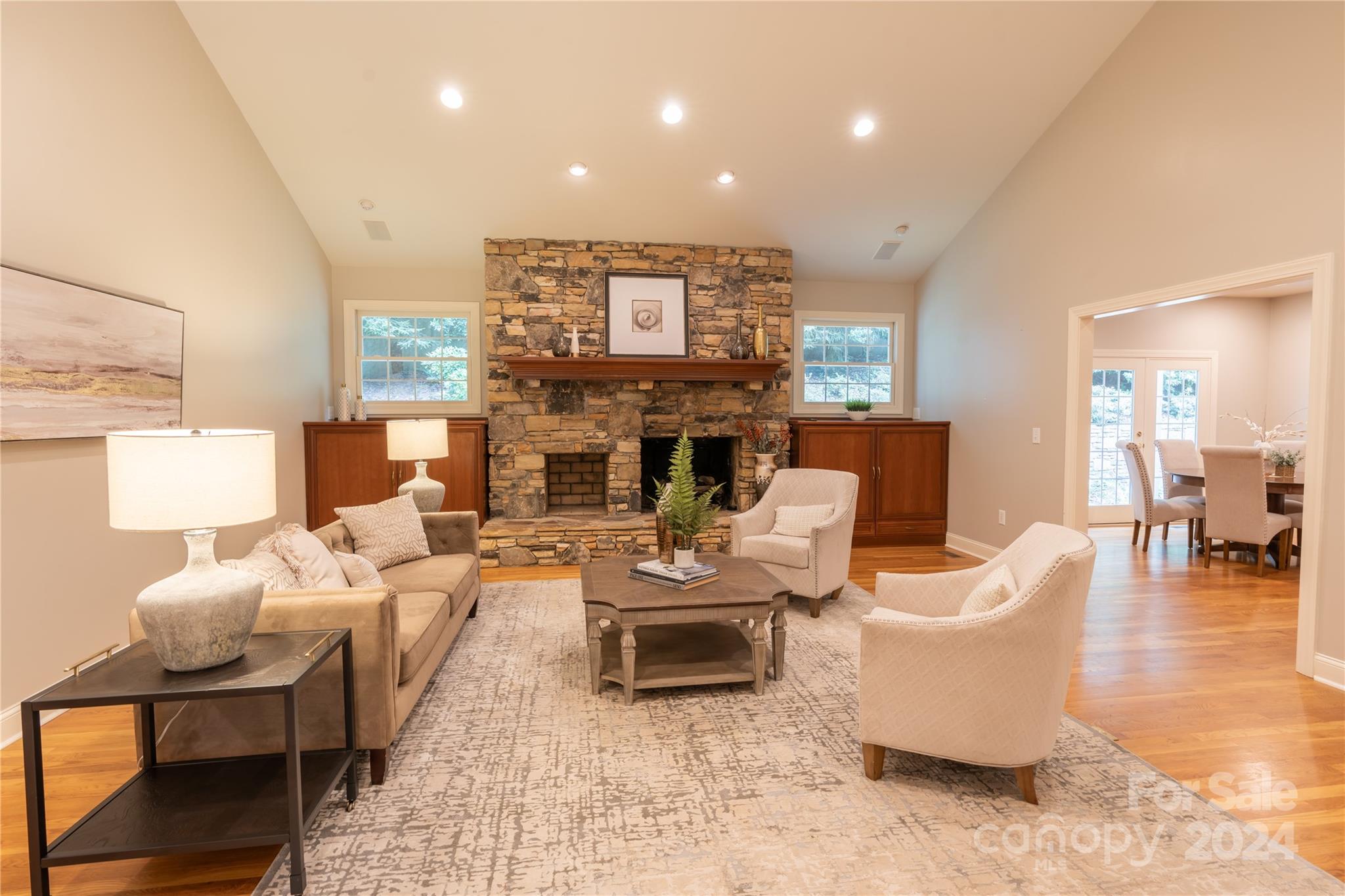 a living room with furniture a fireplace and a table