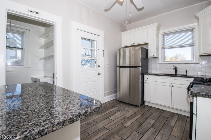 a kitchen with a refrigerator sink and cabinets