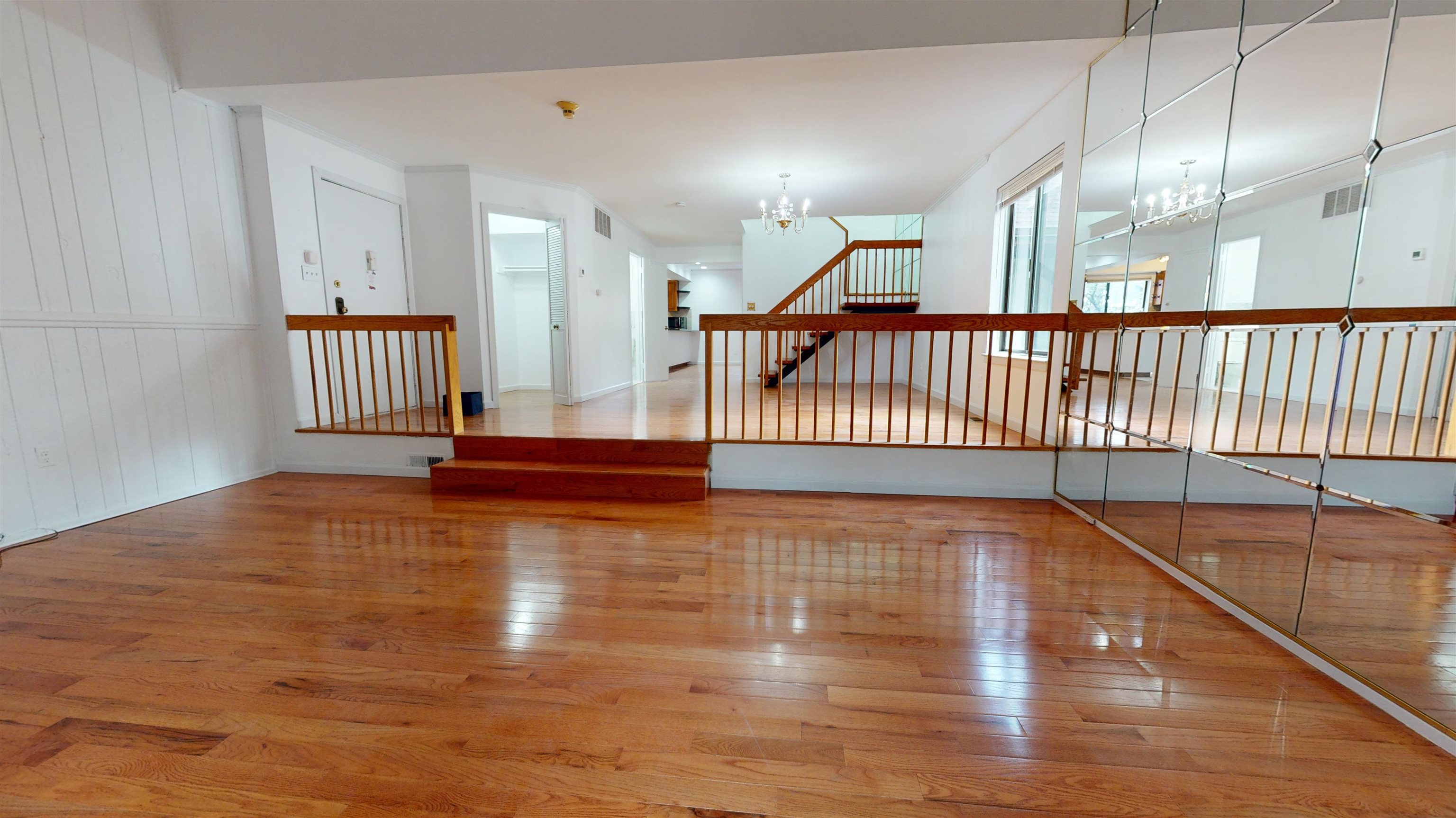 a view of a room with wooden floor