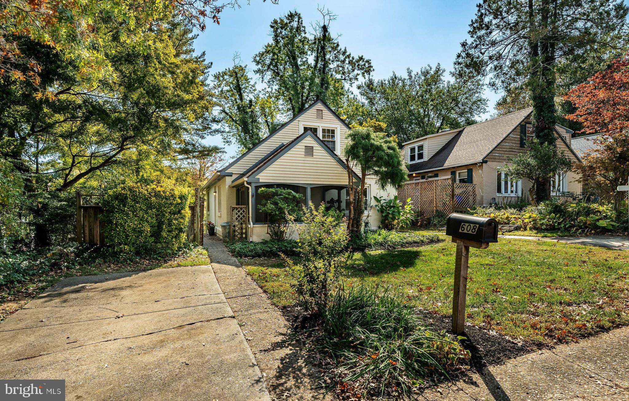 a front view of a house with a yard and trees