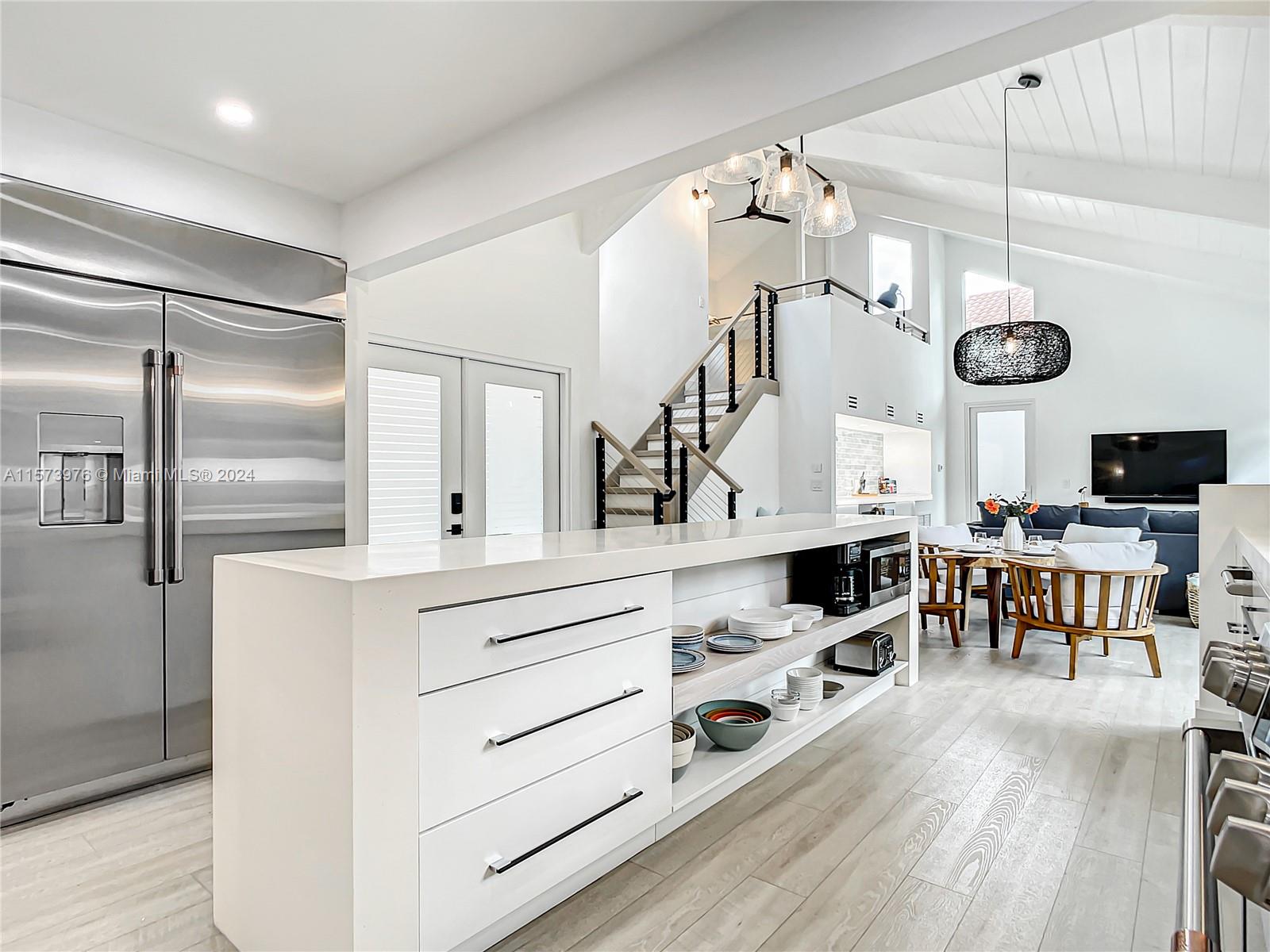 a kitchen with cabinets and stainless steel appliances