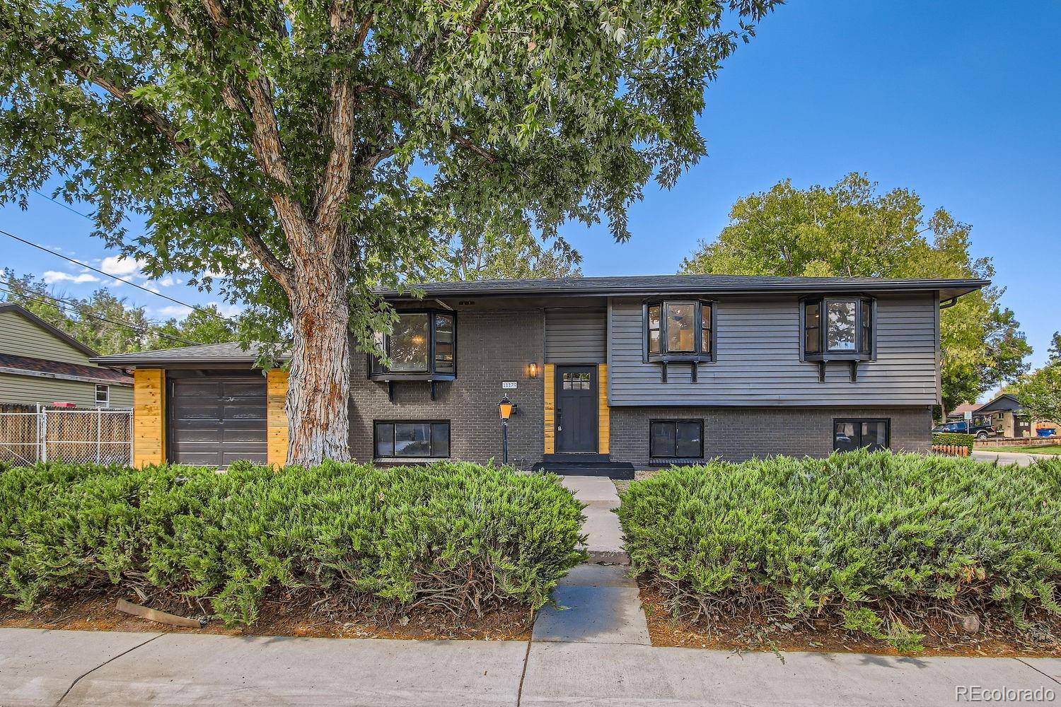 front view of a house with a tree