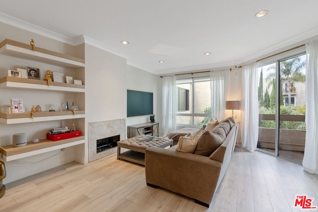 a living room with furniture flat screen tv and a large window