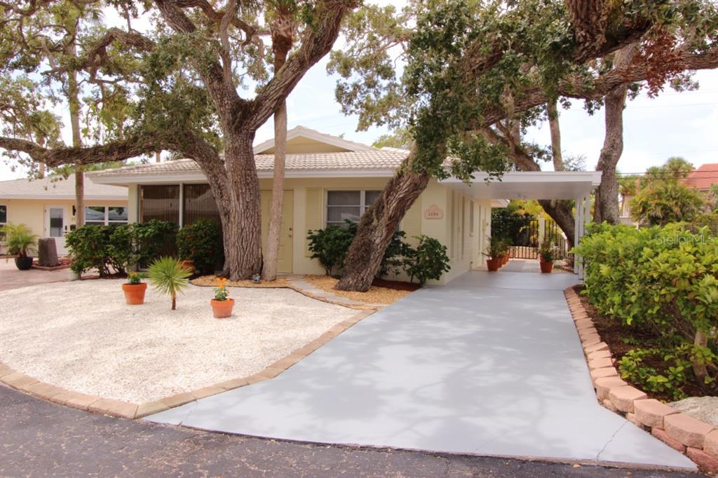 a view of a house with backyard and sitting area