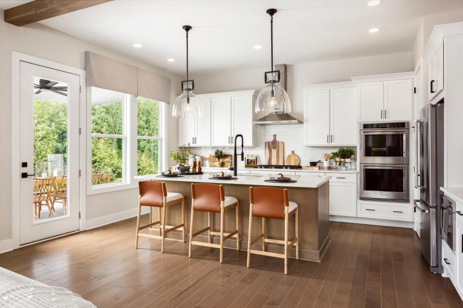 a large kitchen with a table and chairs