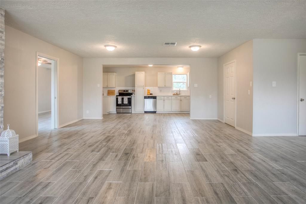 a view of kitchen with cabinets and wooden floor