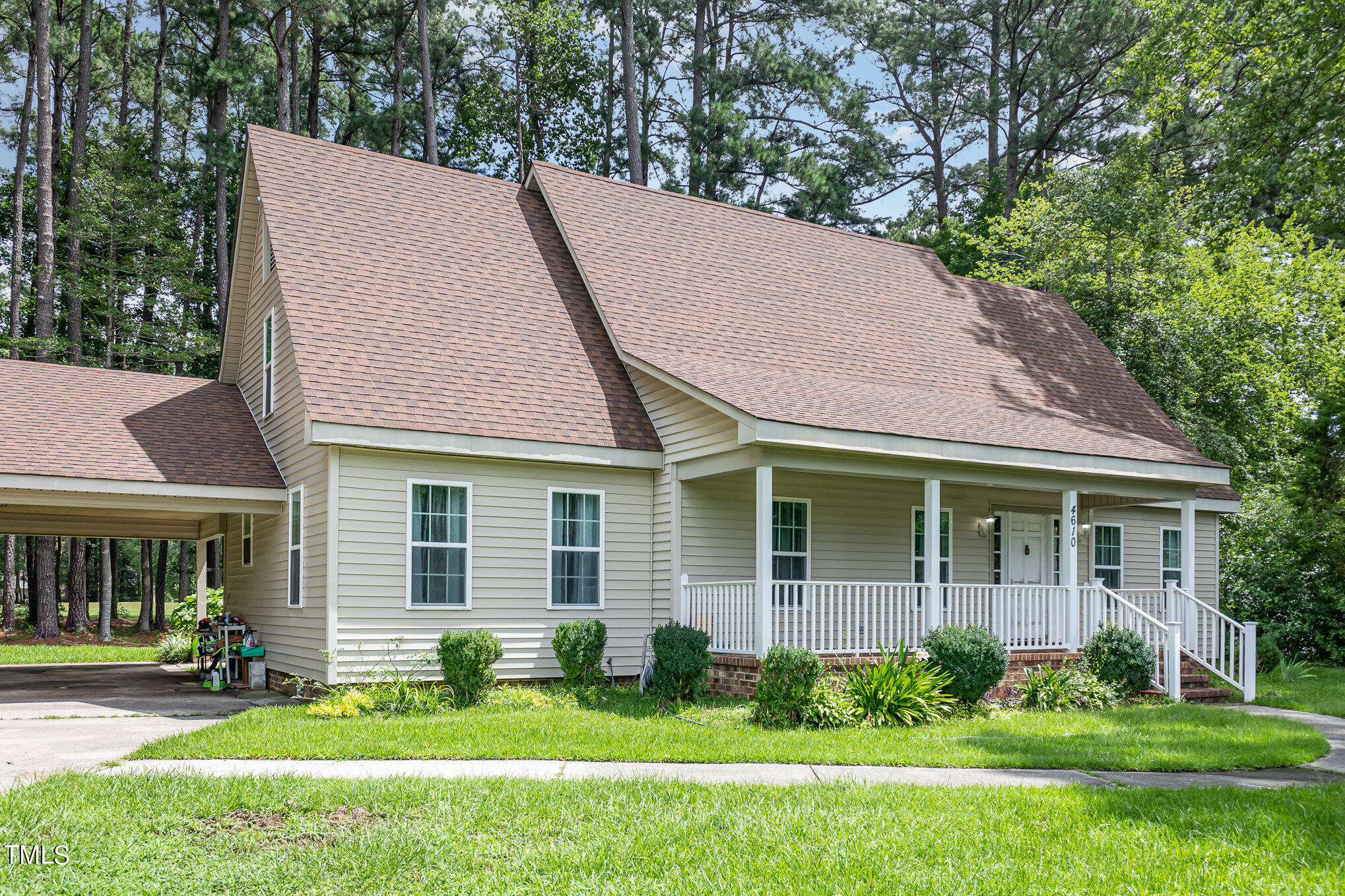 a aerial view of a house with yard and green space