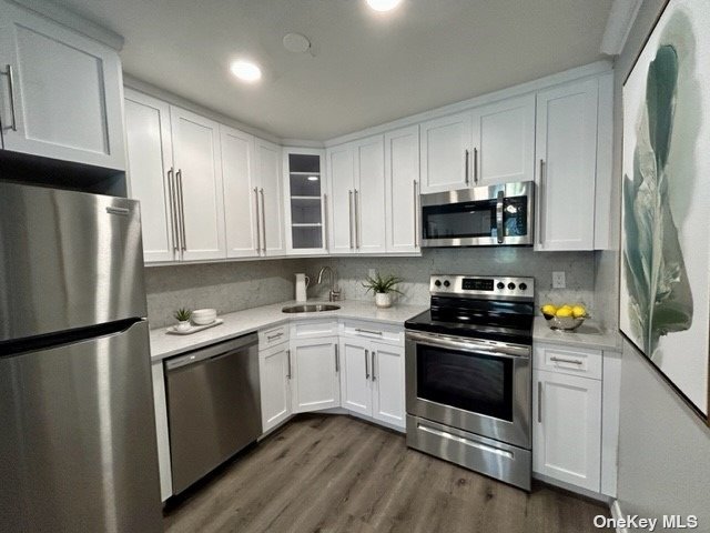 a kitchen with stainless steel appliances and white cabinets