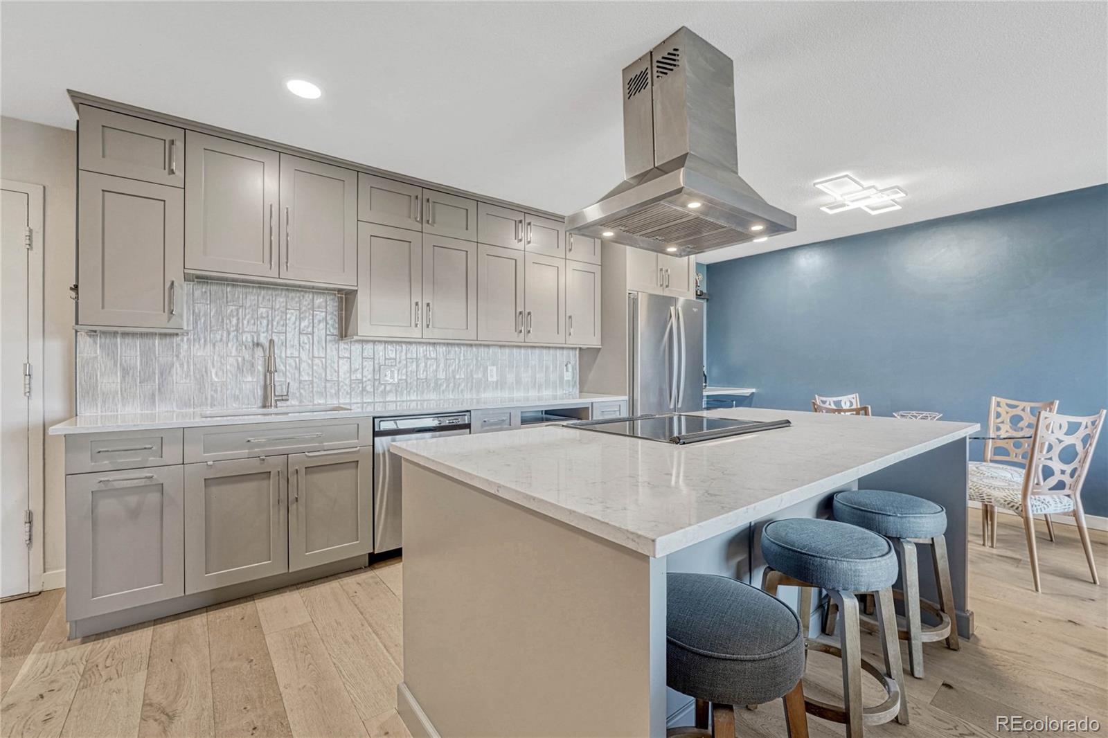 a kitchen with a table chairs sink and cabinets