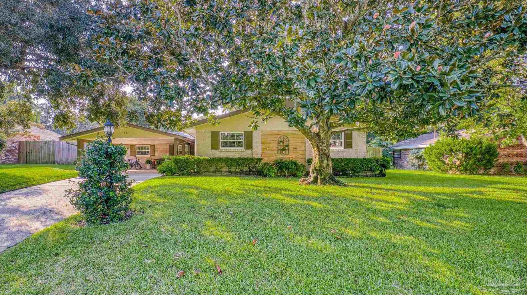 a front view of house with yard and green space