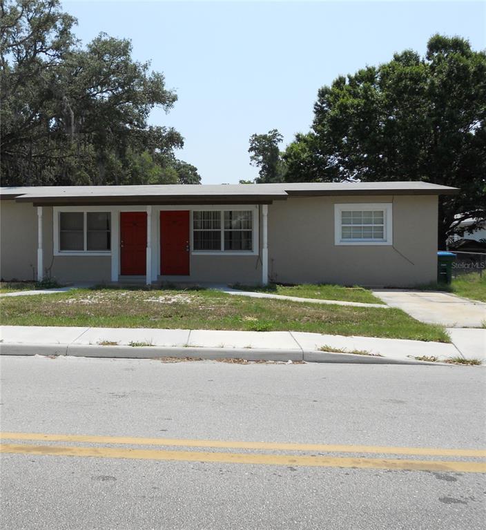 a front view of a house with a yard and a garage