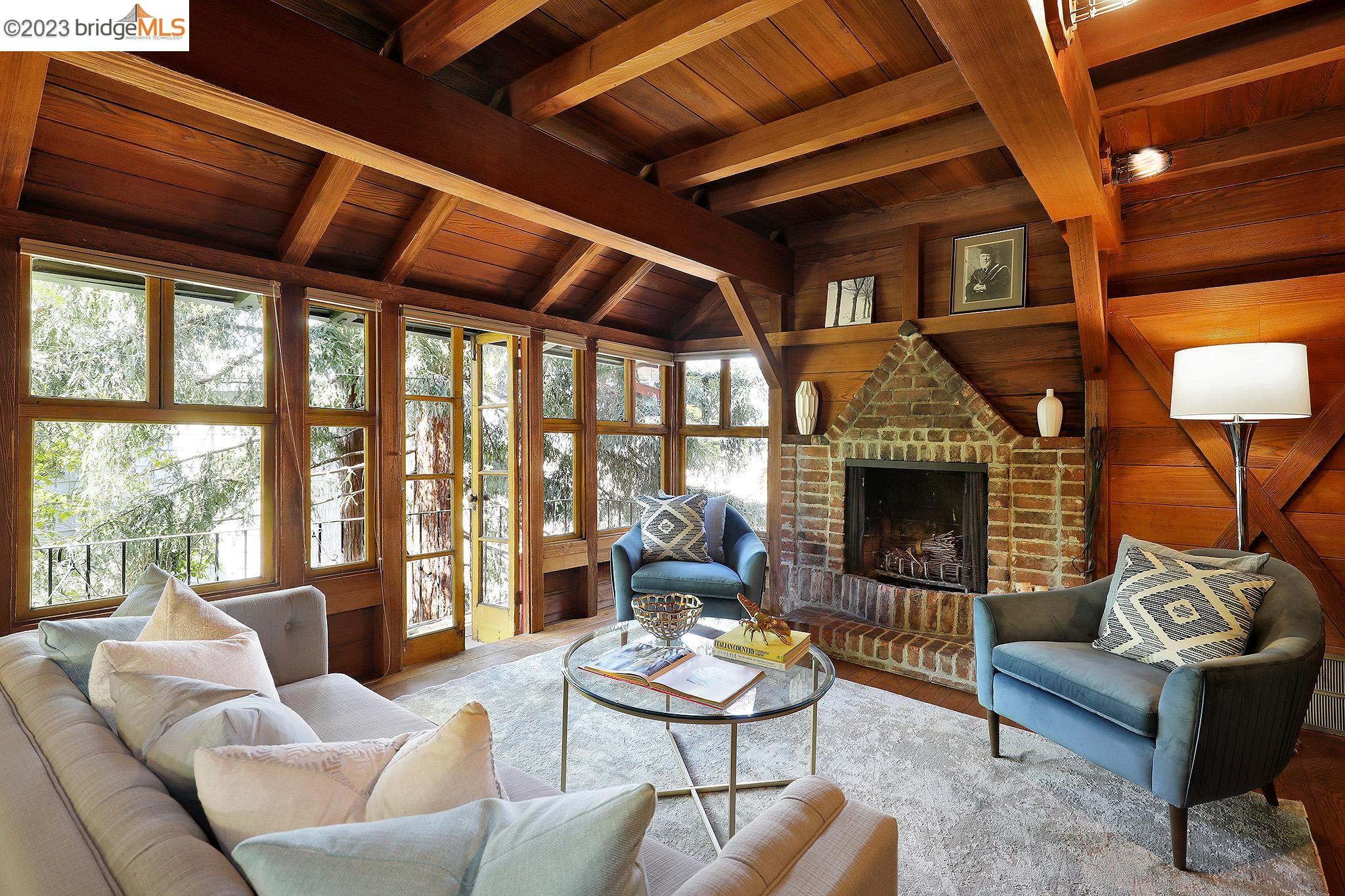 a living room with furniture a fireplace and a table