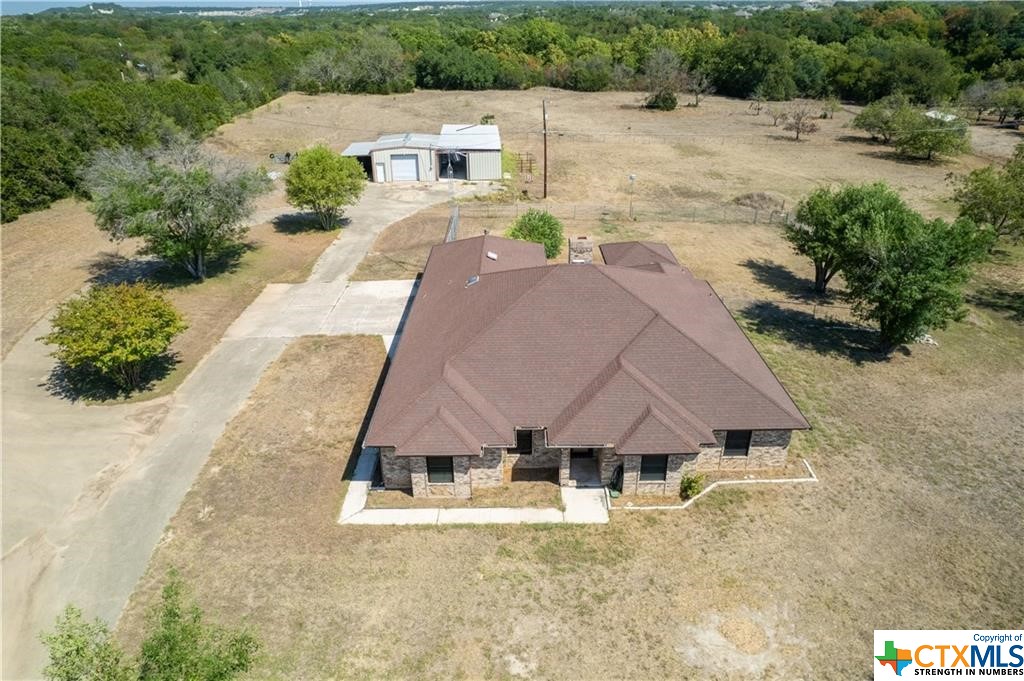 a aerial view of a house with a yard and garage